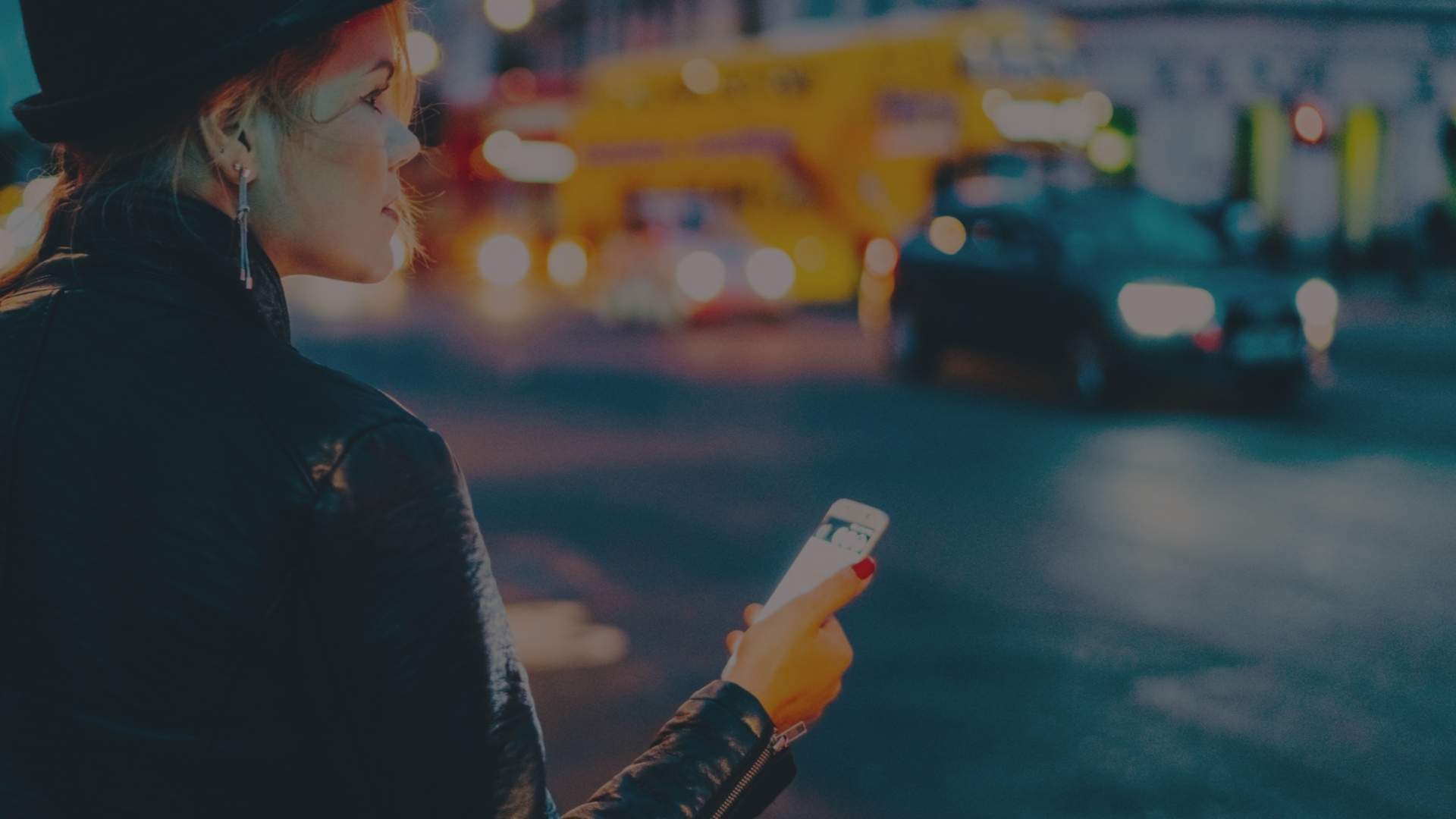 woman holding phone in the street
