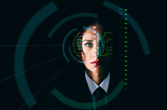 young female simulating biometric eye scanning