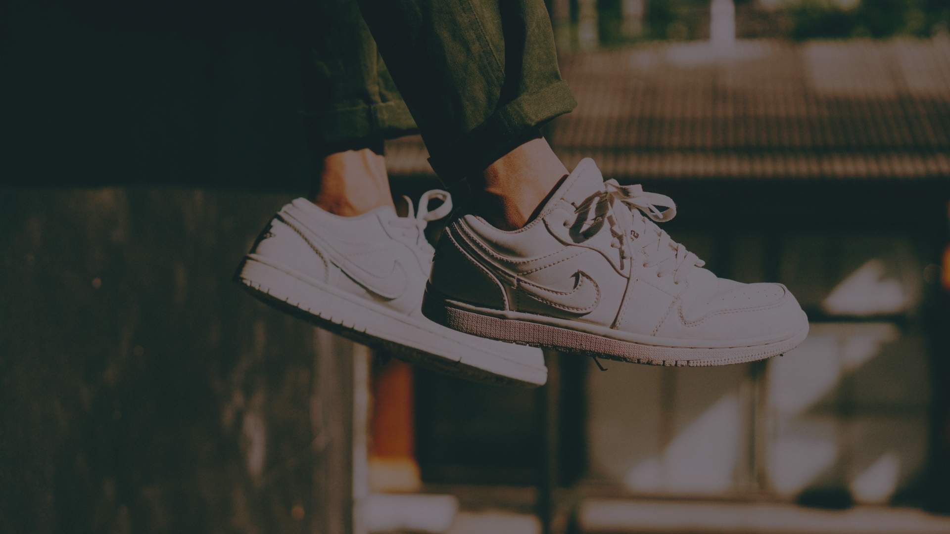 person wearing white nike sneakers