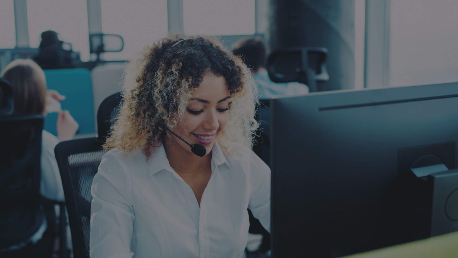 women in front of a laptop at an office