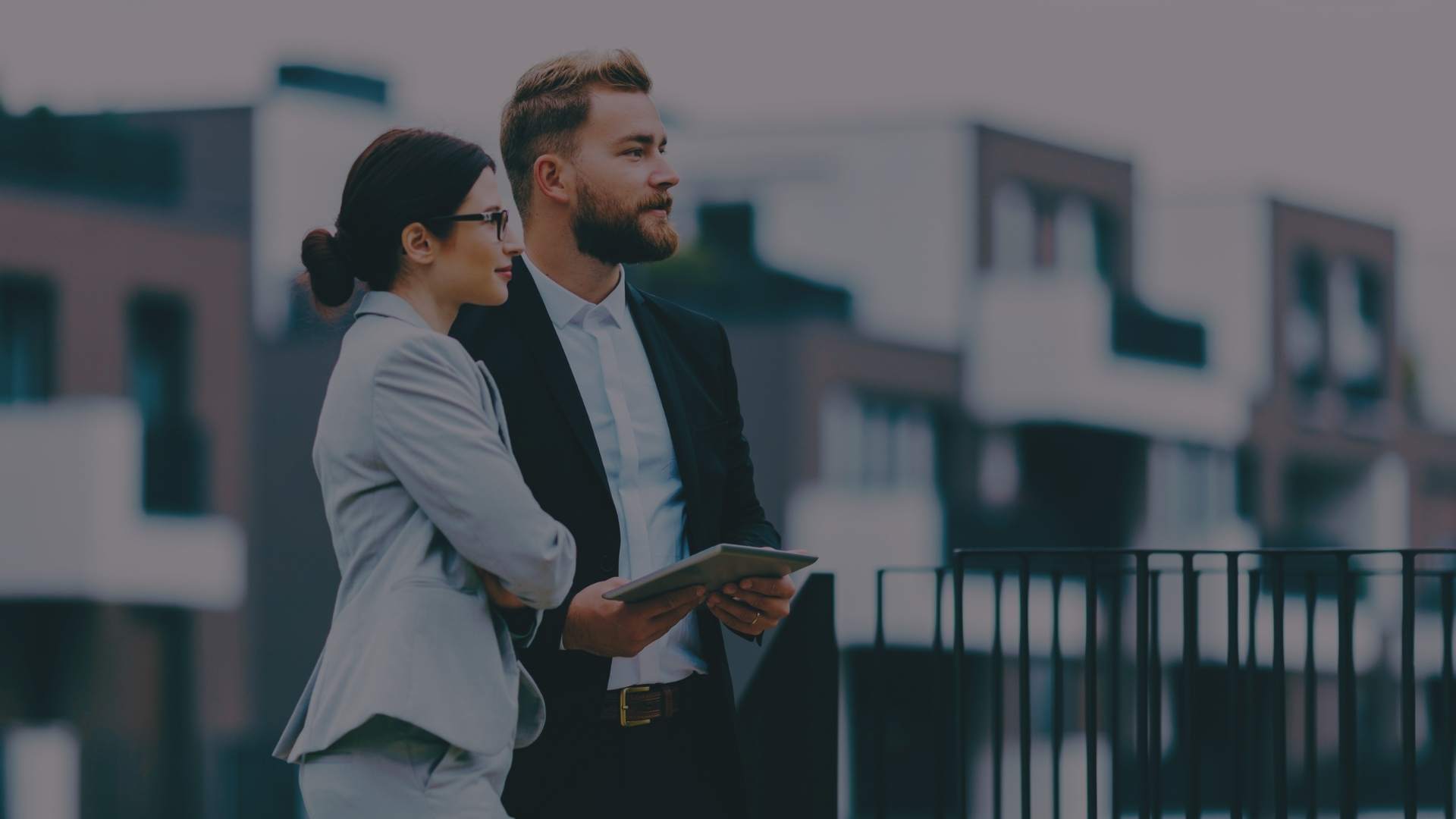 two real estate professionals talking in the street