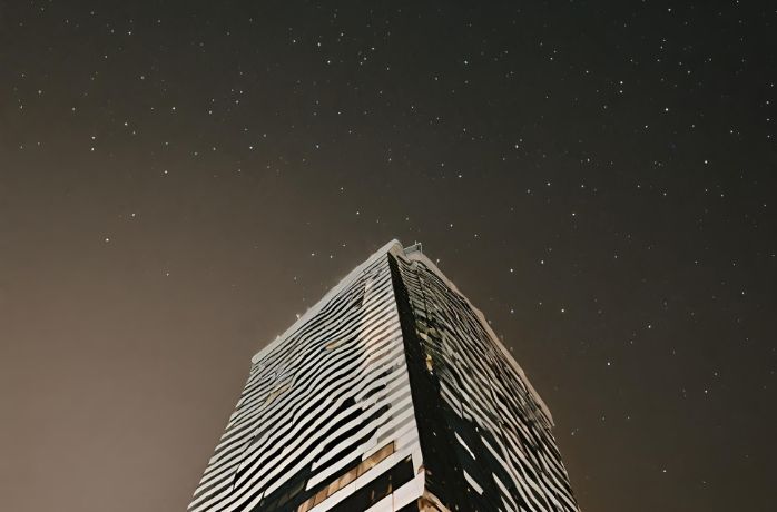 tall modern building on a starring night