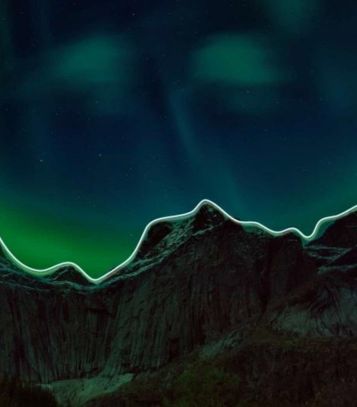mountains under a aurora borealis sky